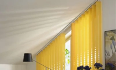 Gelbe Vertikaljalousien an einem Fenster mit Dachschräge verleihen dem Raum Farbe.